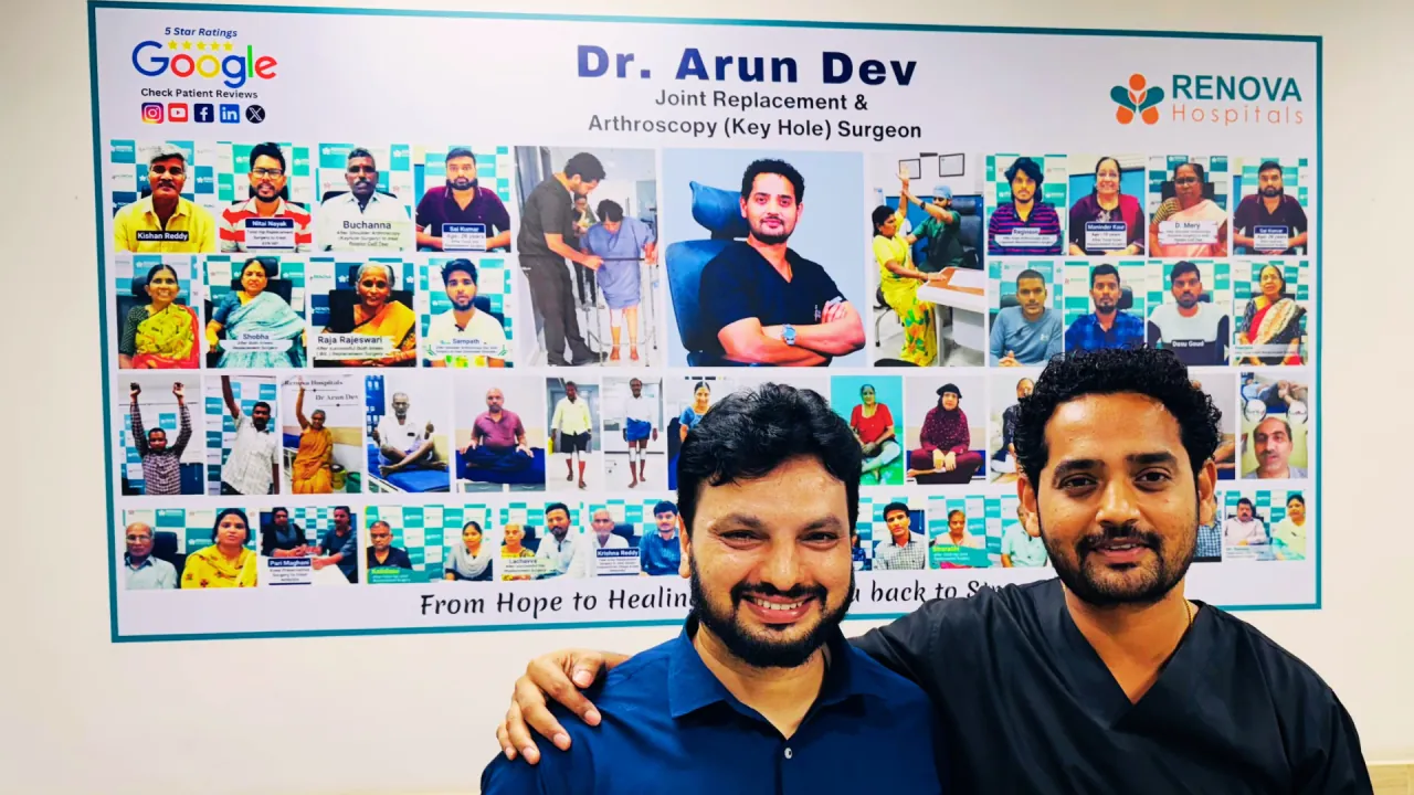 Dr. Arun Dev and Syed Nyamathullah in front of his patient story wall
