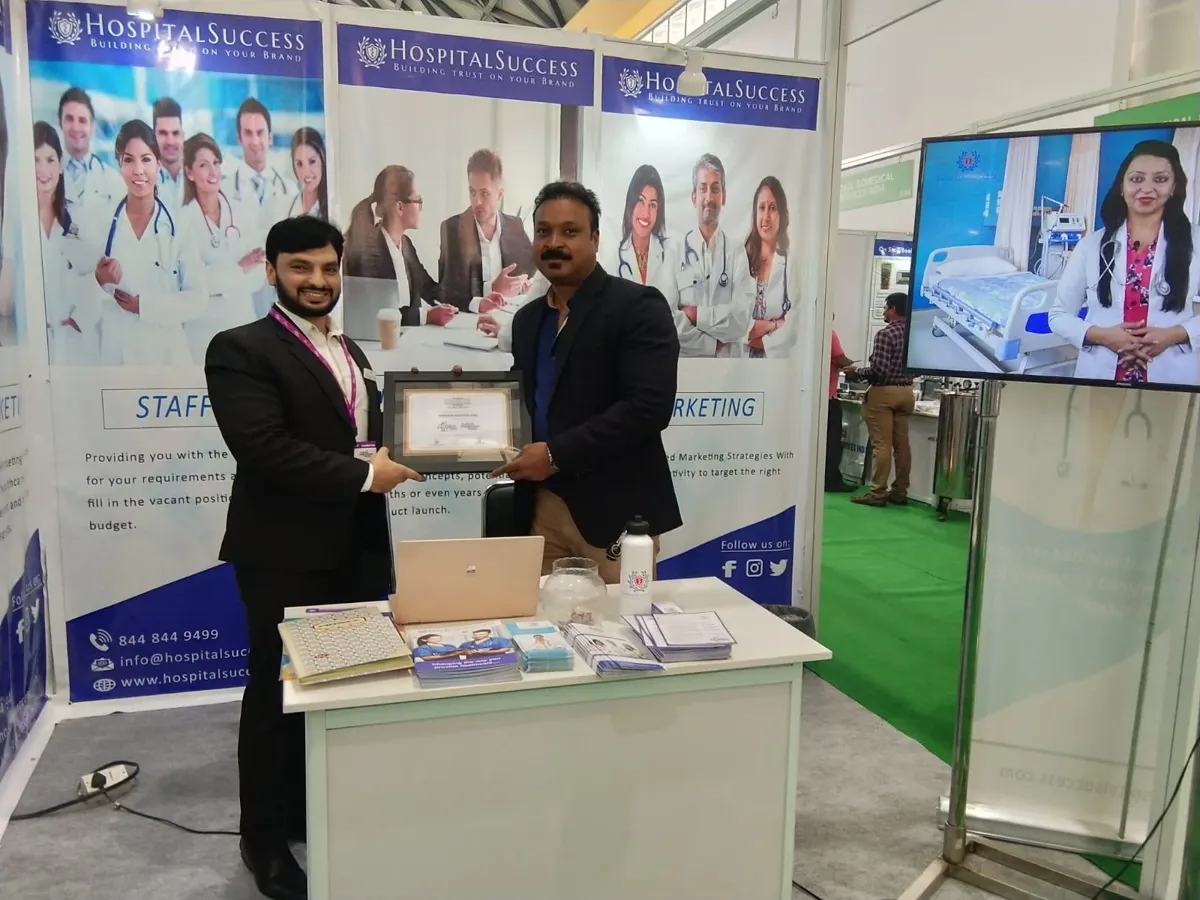 Syed Nyamathullah receiving a recognition at a medical expo